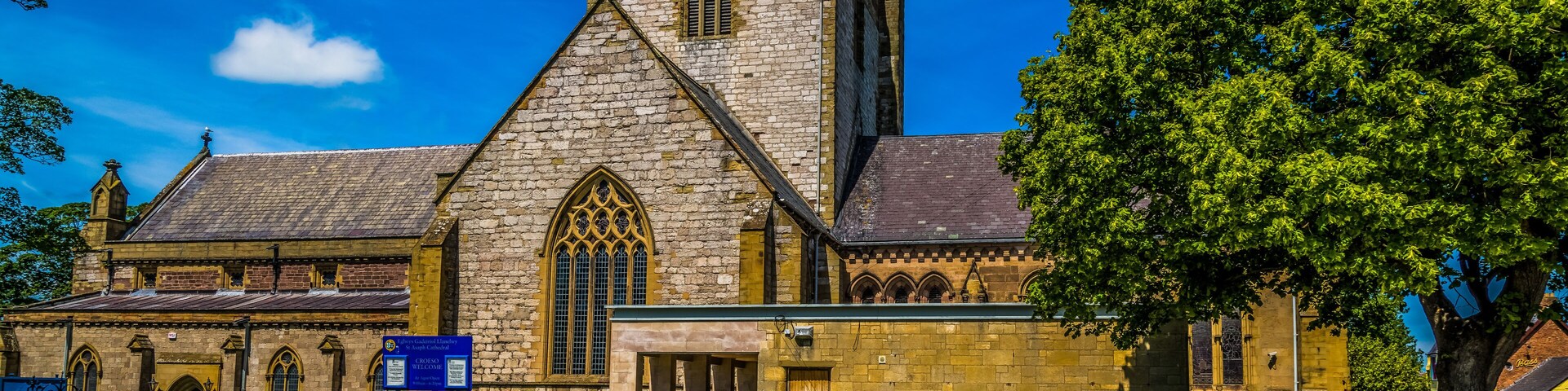 A historic church with a tall tower and arched windows.