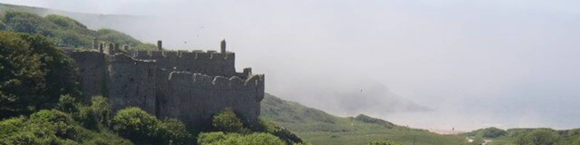 Manorbier castle with the sea mist rolling in.