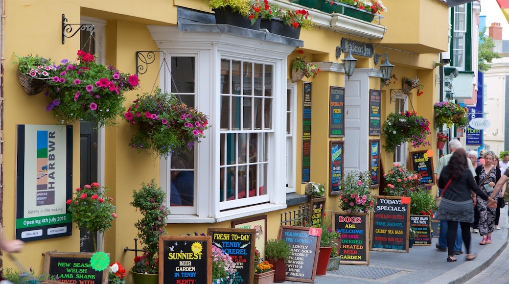 Tenby featuring flowers, markets and signage