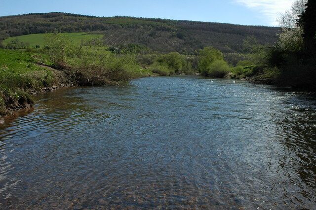 River Usk, Newbridge on Usk The River Usk at Newbridge on Usk with the wooded Wentworth Hill in the background.
