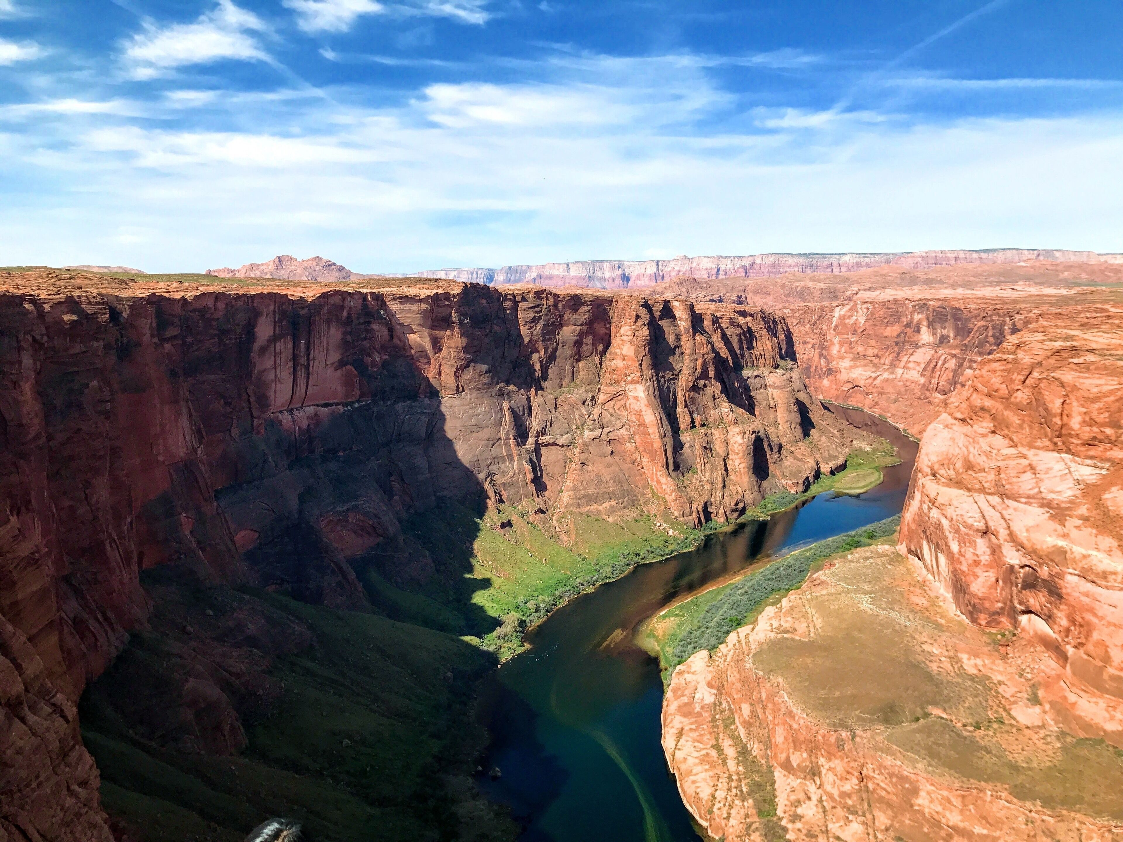 A canyon with steep cliffs and a river.