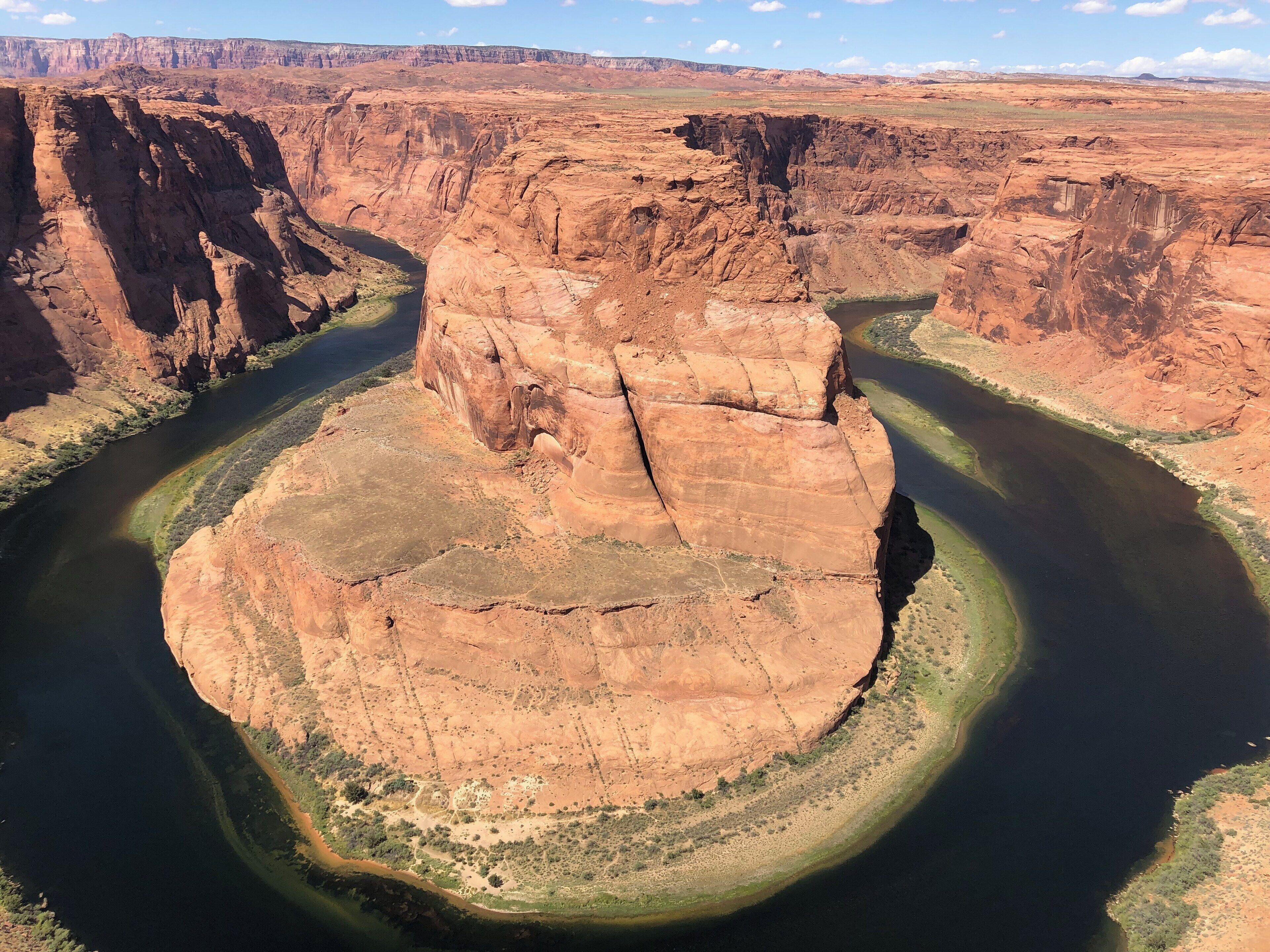 A canyon with a river winding through it.
