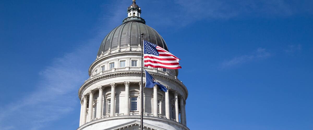 A large domed building with an American flag.