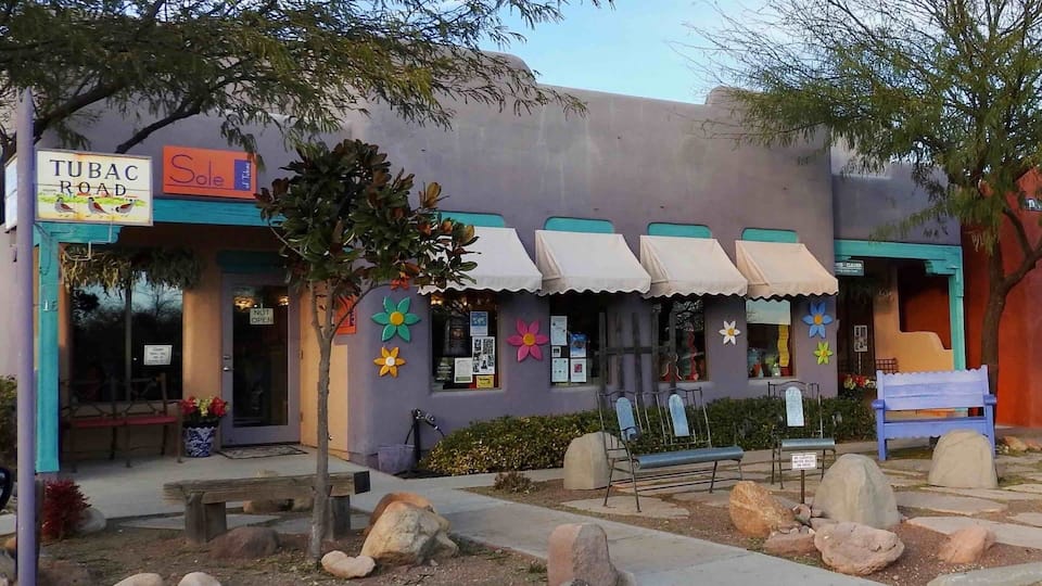 A building with a sign reading "TUBAC ROAD" and "Sole."