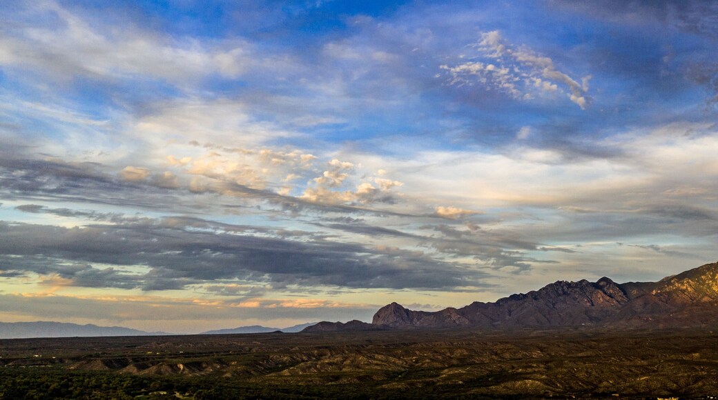 Sunset, aerial landscapes of Santa Rita Mountains from above Tubac, Arizona with warm , golden plains, purple mountains, blue sky with colorful clouds on a Fall day