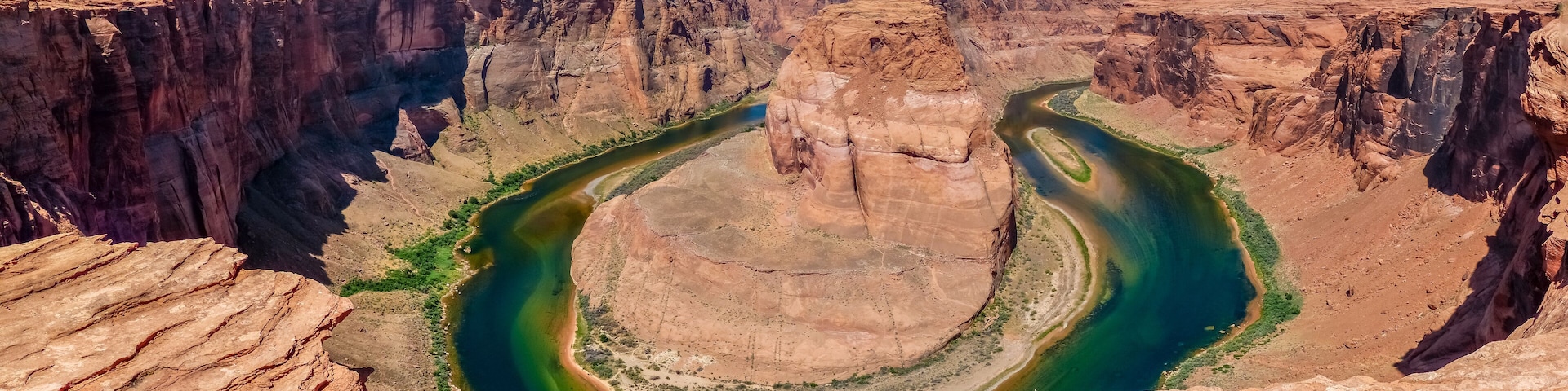 A deep canyon with a river winding through it.