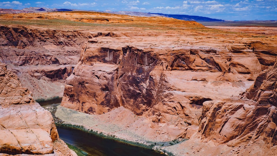 A canyon with a river flowing through it.