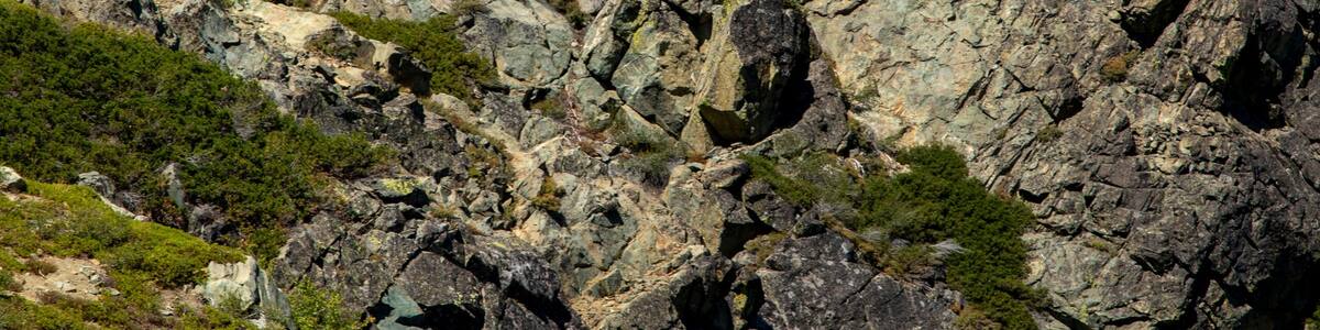 A rocky mountain with a lookout tower on top.