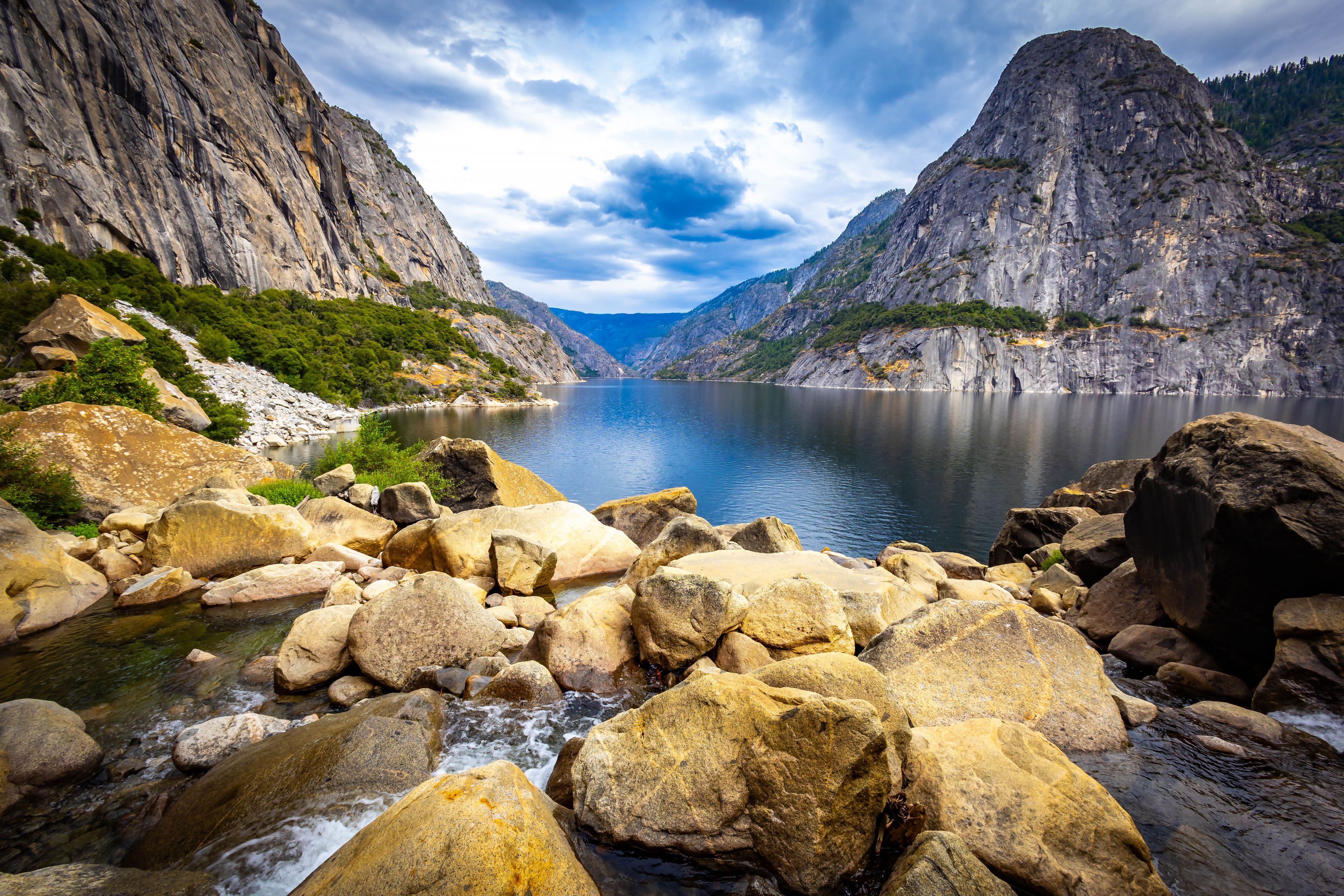 A mountainous landscape with a river flowing through a rocky gorge.