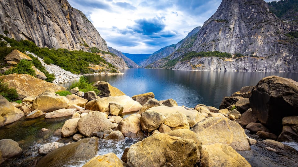 A mountainous landscape with a river flowing through a rocky gorge.