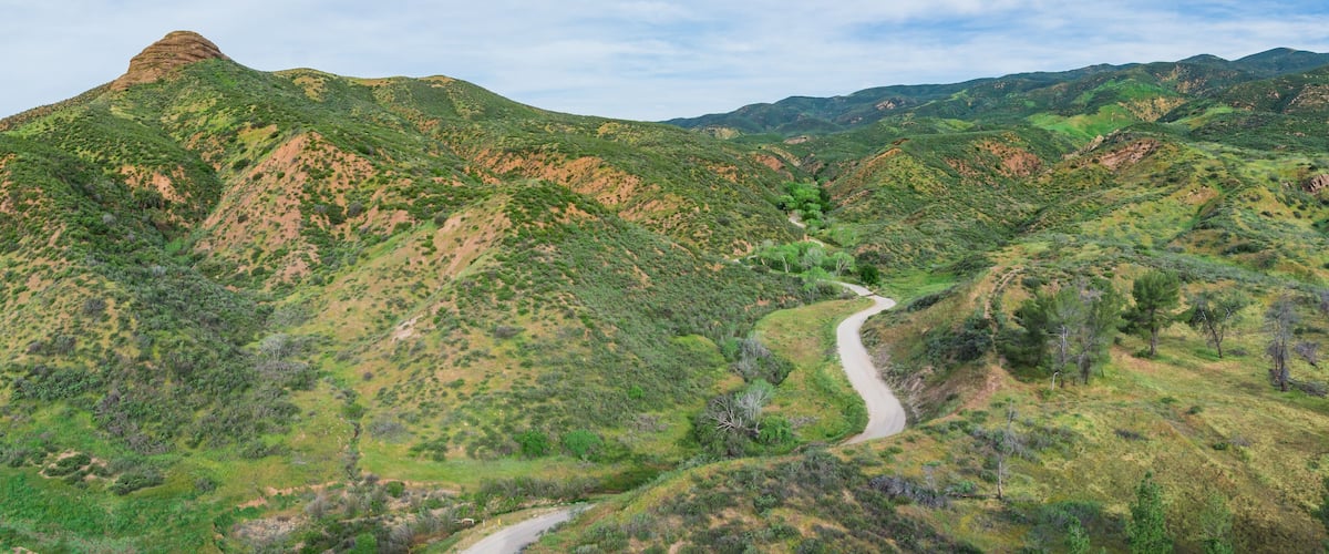 Low hills and canyons with a road leading into the California natural wilderness.