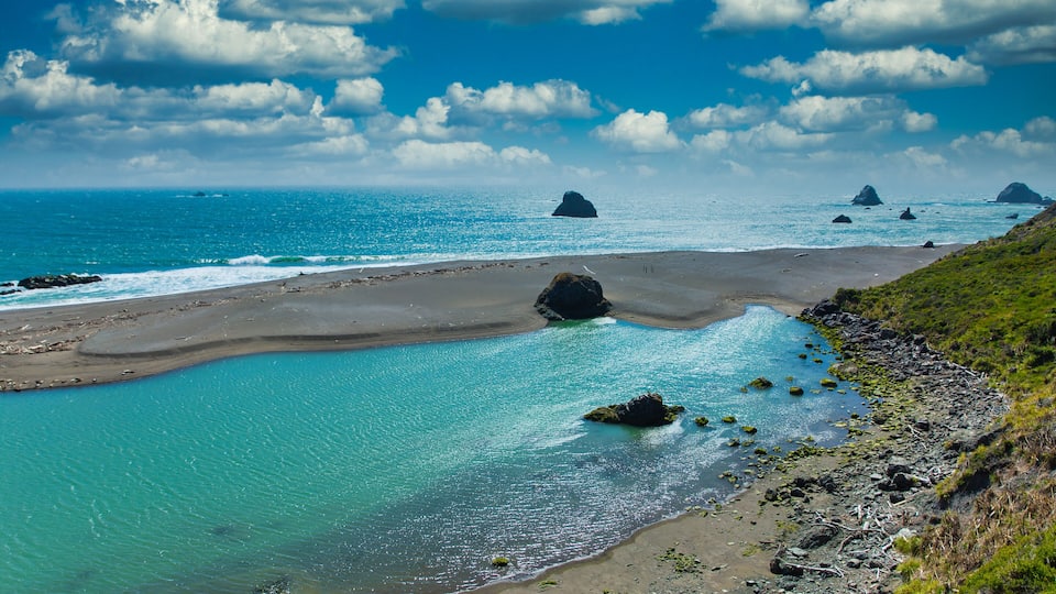 Rocks and beach of Russian River empying into Pacific Ocean at Jenner, California