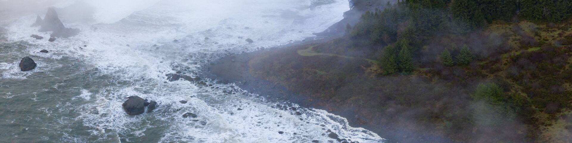 The marine layer drifts over the amazing coastline of Northern California in Klamath. This incredible region is home to the world's most beautiful temperate forests. Redwood trees are common here.