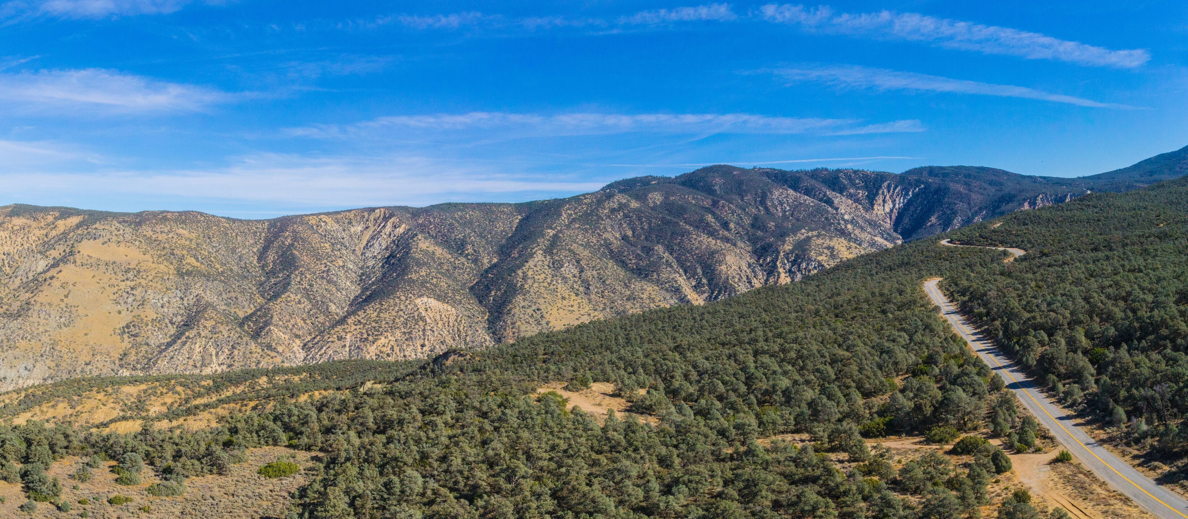Highway runs across a mountain ridgeline in the California wilderness.