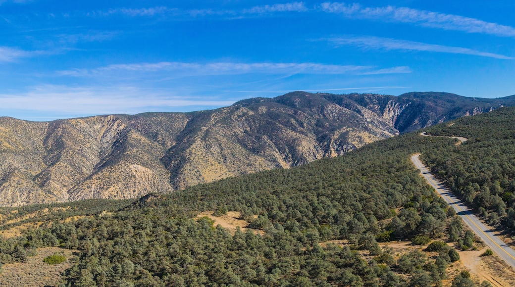 Highway runs across a mountain ridgeline in the California wilderness.