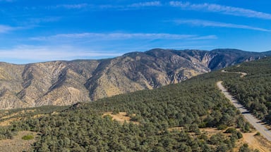 Highway runs across a mountain ridgeline in the California wilderness.