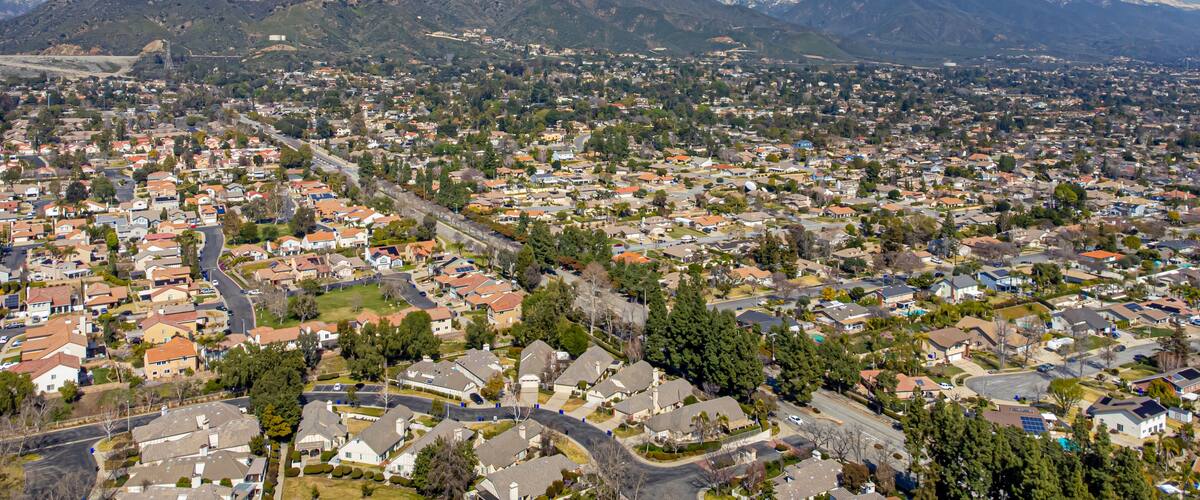 A town with snow-capped mountains in the background.