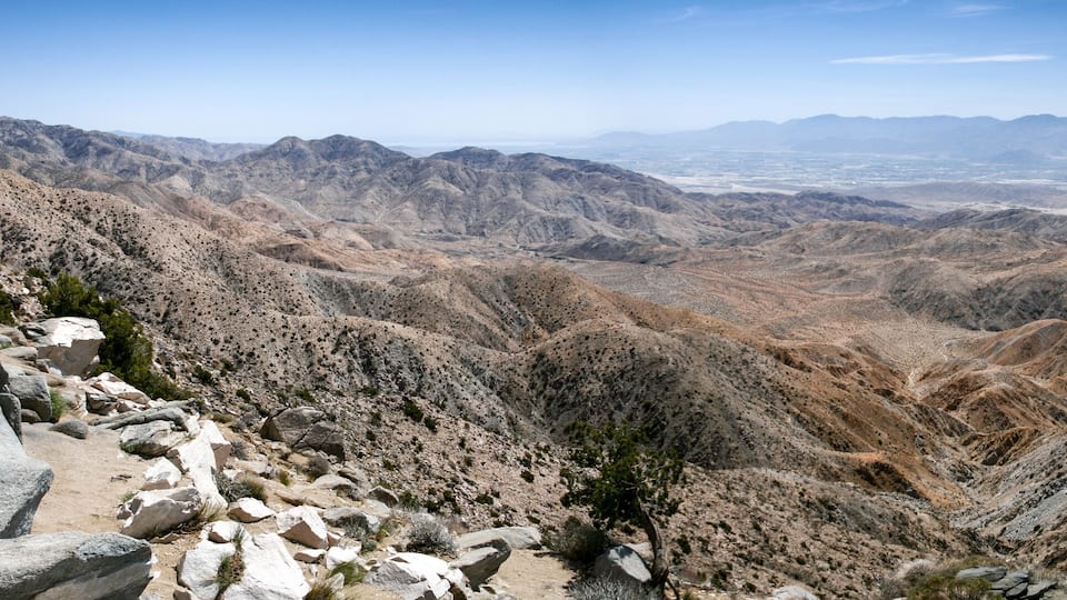 A rugged mountainous landscape with rocky terrain and sparse vegetation.