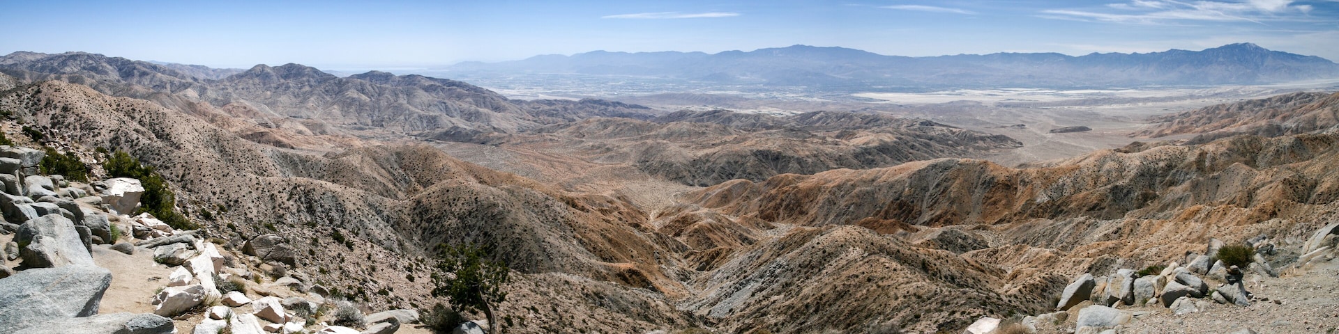 Un paisaje montañoso y agreste con terreno rocoso y vegetación escasa.