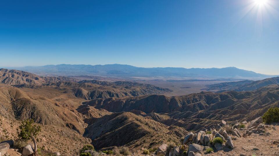 A mountainous landscape with rocky terrain and sparse vegetation.