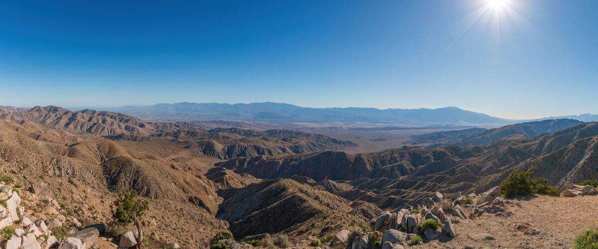A mountainous landscape with rocky terrain and sparse vegetation.