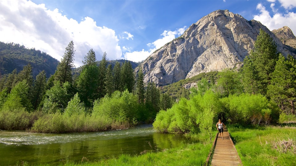 A river, a wooden bridge, and a mountain.