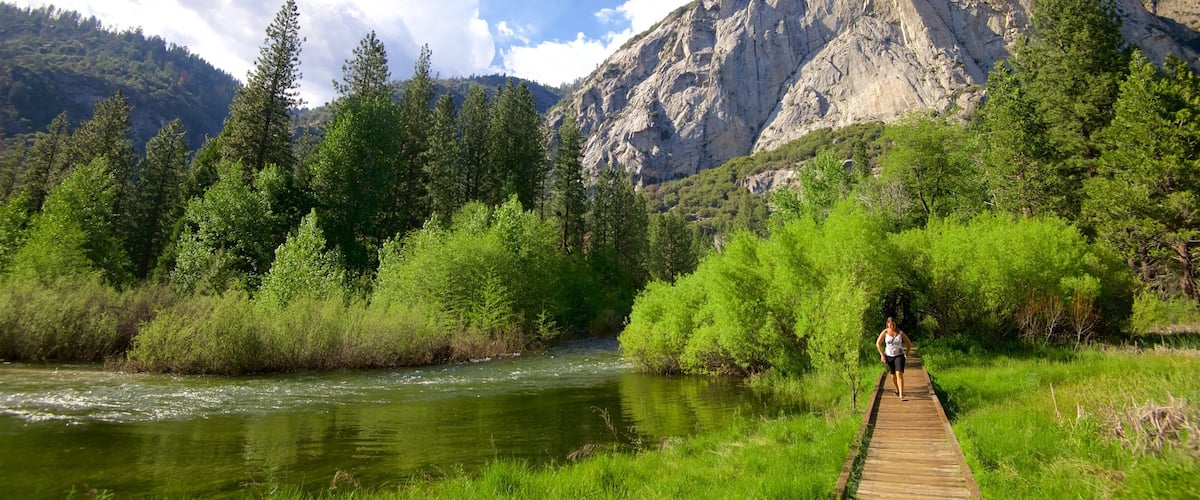 A river, a wooden bridge, and a mountain.