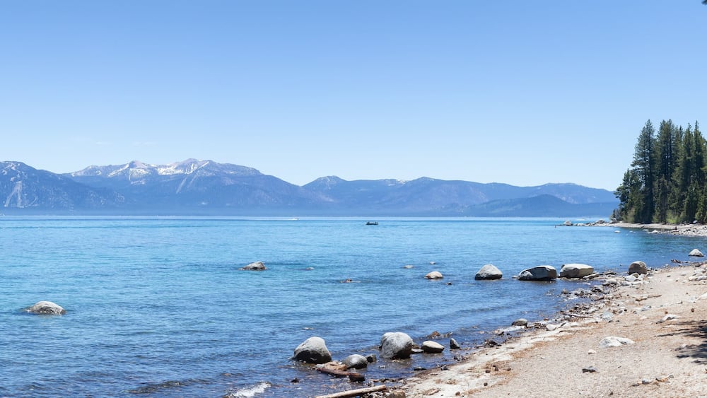 Panoramic View of Rocky Beach and Dock at the Lake surrounded by Mountains and Trees. Summer Season. Sugar Pine Point Beach, Tahoma, California, United States. Sugar Pine Point State Park. Panorama