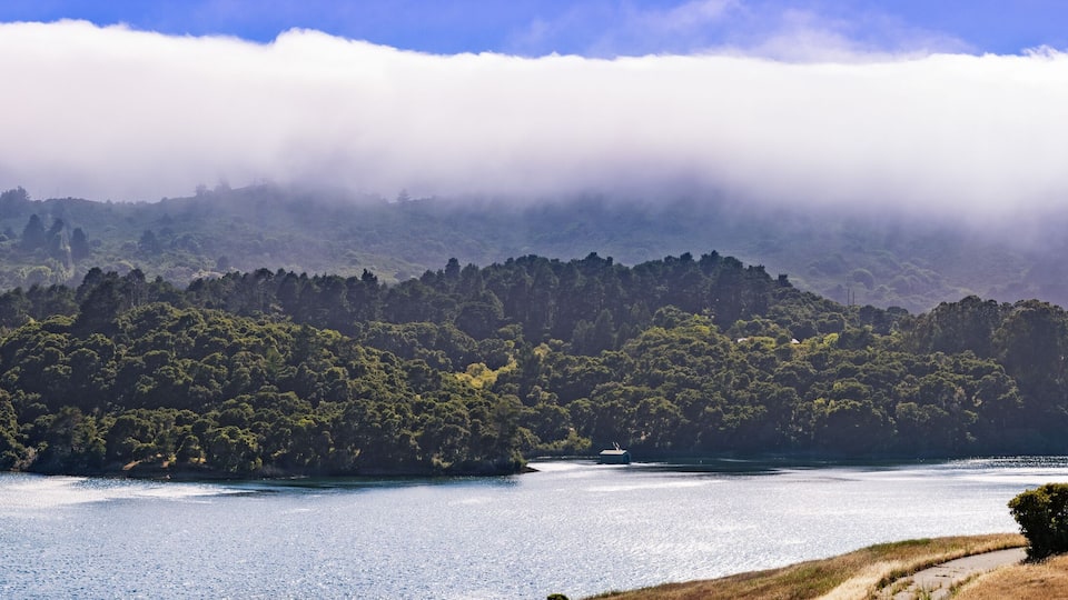 A lake surrounded by forested hills and a small island.