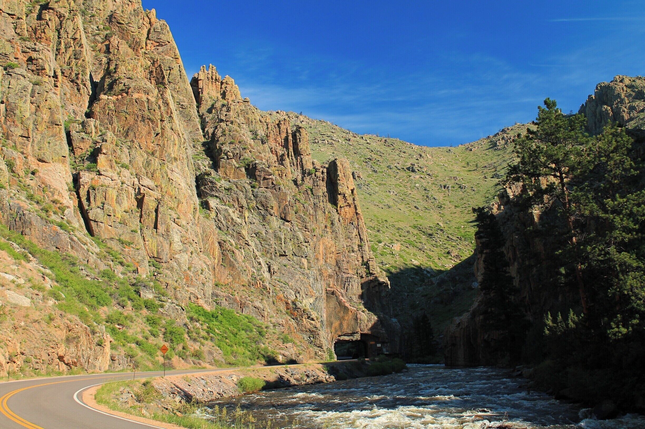 Driving along the Cache la Poudre Scenic Byway, you come to this tunnel that travels through the rock wall of the canyon. Don't worry - it's a very short tunnel, but still pretty awesome! #weekendgetaway #CacheLaPoudreWilderness #ScenicByway #mountains #colorado #PoudreRiver  #Wilderness #Walden