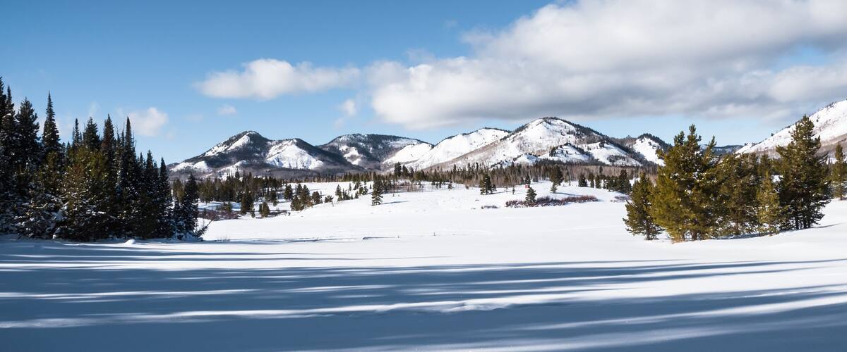 A snowy mountain landscape with clear skies.