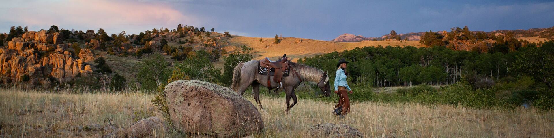 Cowgirl leading horse