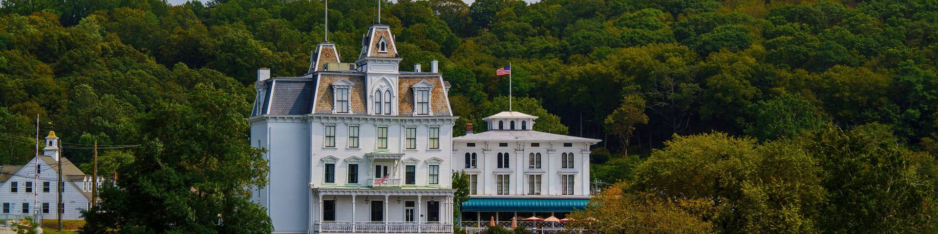Connecticut River Autumn Landscape with the view of landmark architectures on the woodland hill, a tranquil New England scenery