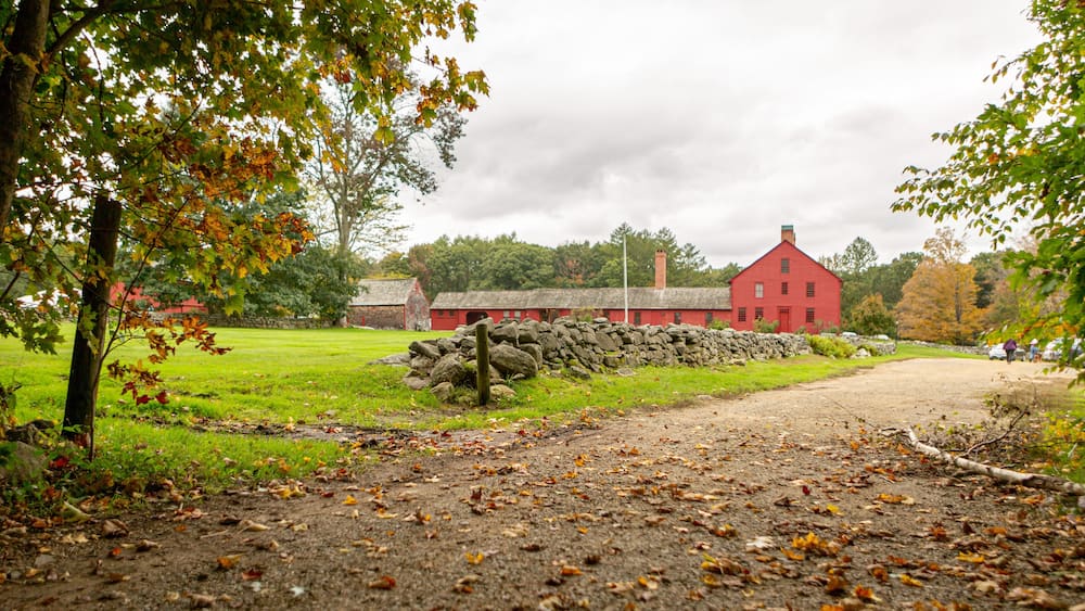 Autumn path leading to historic red house