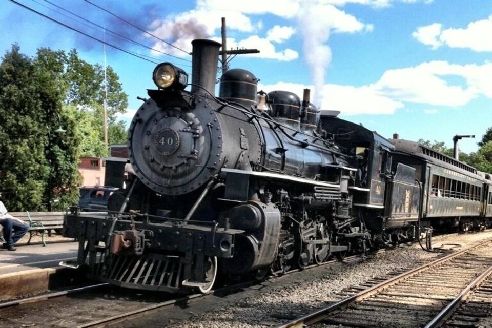 A steam locomotive with the number 40 on its front, traveling on a railway track.