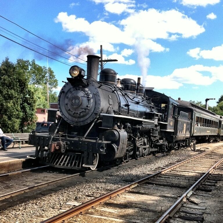 A steam locomotive with the number 40 on its front, traveling on a railway track.