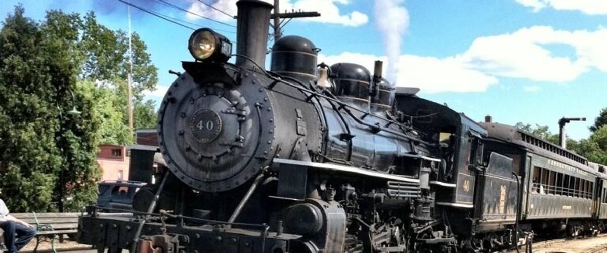 A steam locomotive with the number 40 on its front, traveling on a railway track.