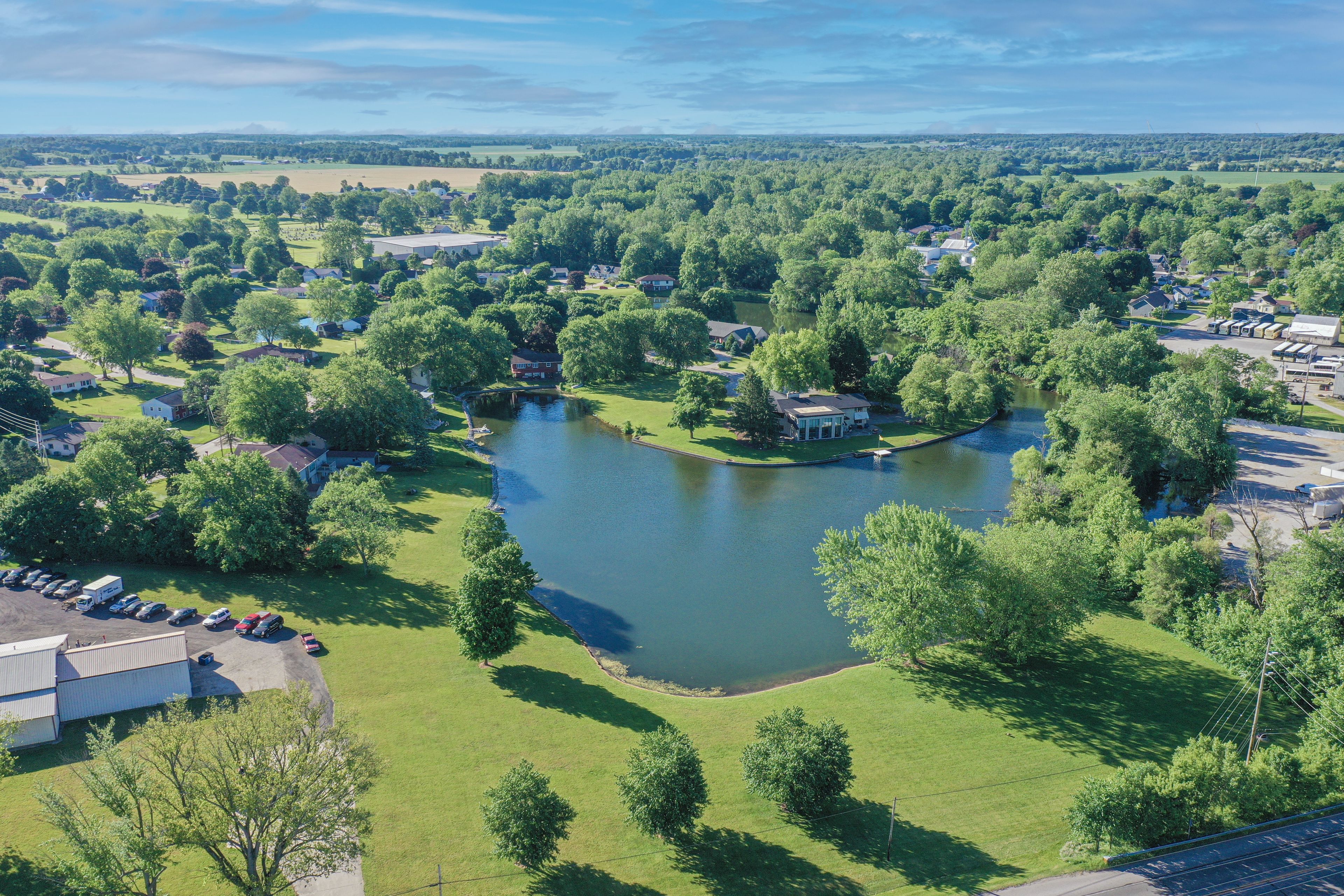 A lake surrounded by residential houses and greenery.