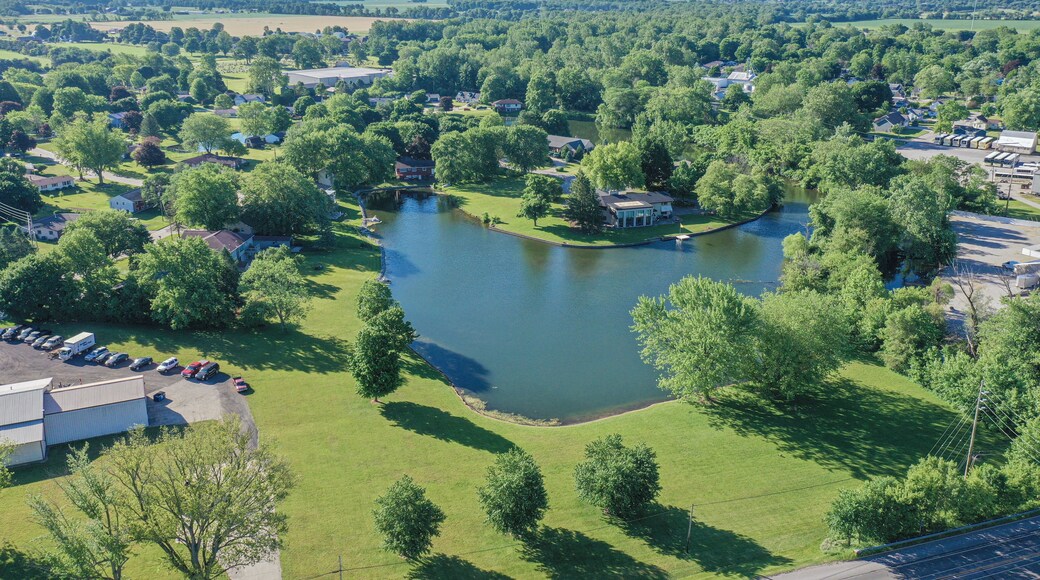 A lake surrounded by residential houses and greenery.