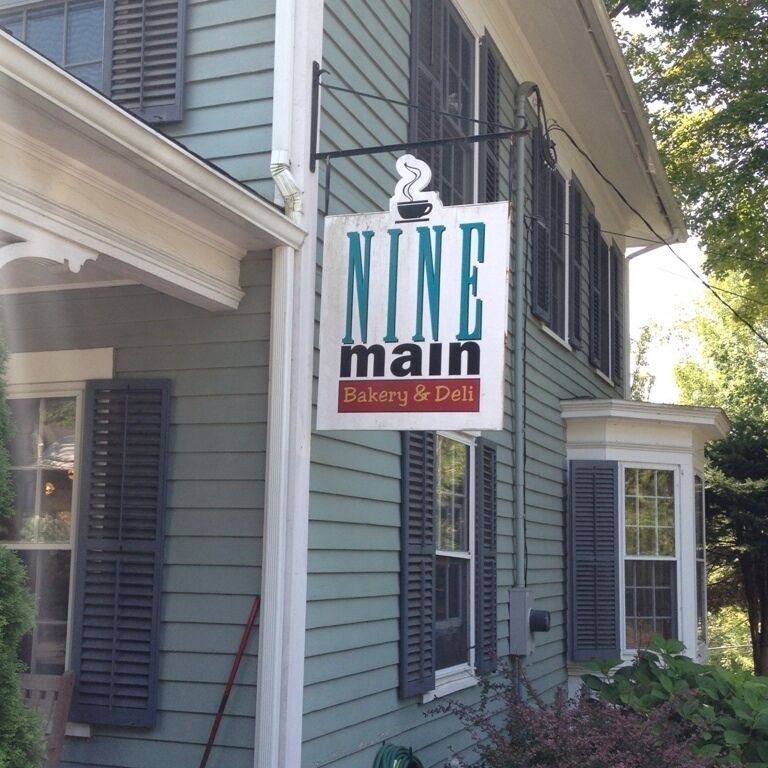 A building with a sign that reads "NINE main Bakery & Deli".