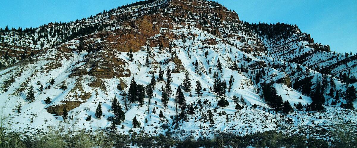 Red-brown rock strata showing through snow near Wolcott, Colorado, USA