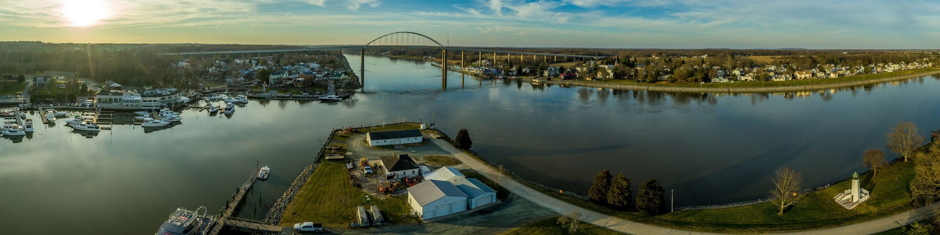 Aerial panorama of Chesapeake City Maryland historic fishing town on the Chesapeake Delaware canal with private boats docked in the marina and the Chesapeake City Bridge over the back creek