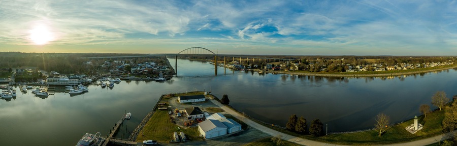 Aerial panorama of Chesapeake City Maryland historic fishing town on the Chesapeake Delaware canal with private boats docked in the marina and the Chesapeake City Bridge over the back creek
