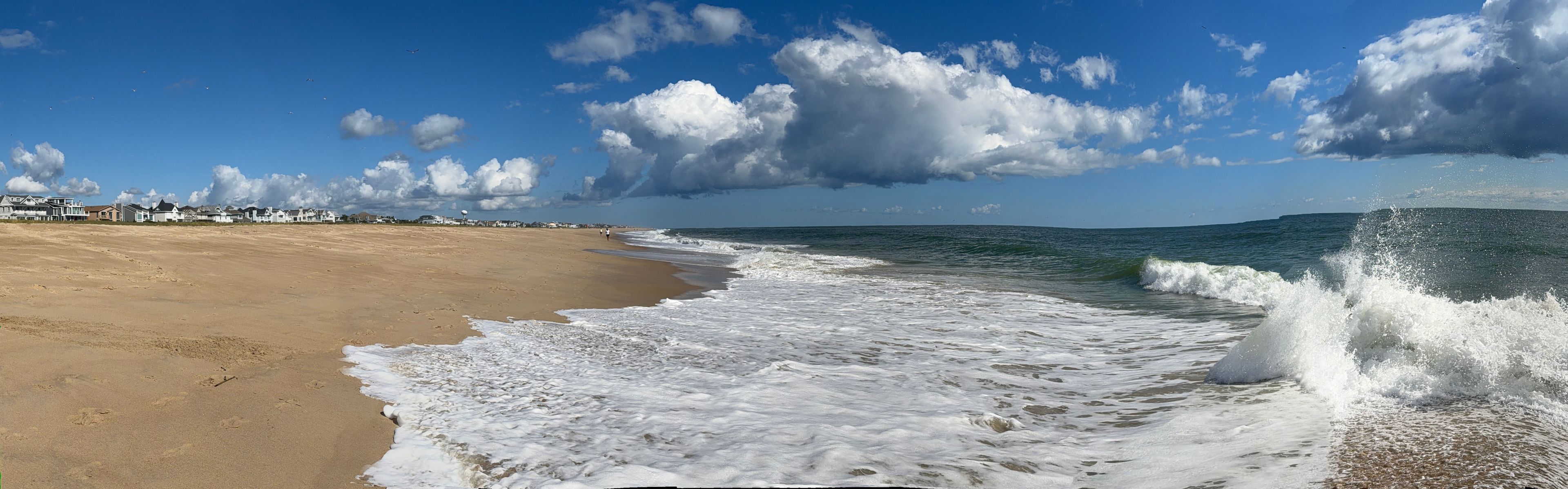 Panorama view of the surf at Bethany Beach in Delaware on Labor Day in early September - the expanse of the Atlantic coast 