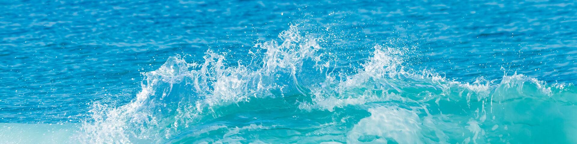 A crystal-clear wave crashing on a Florida beach