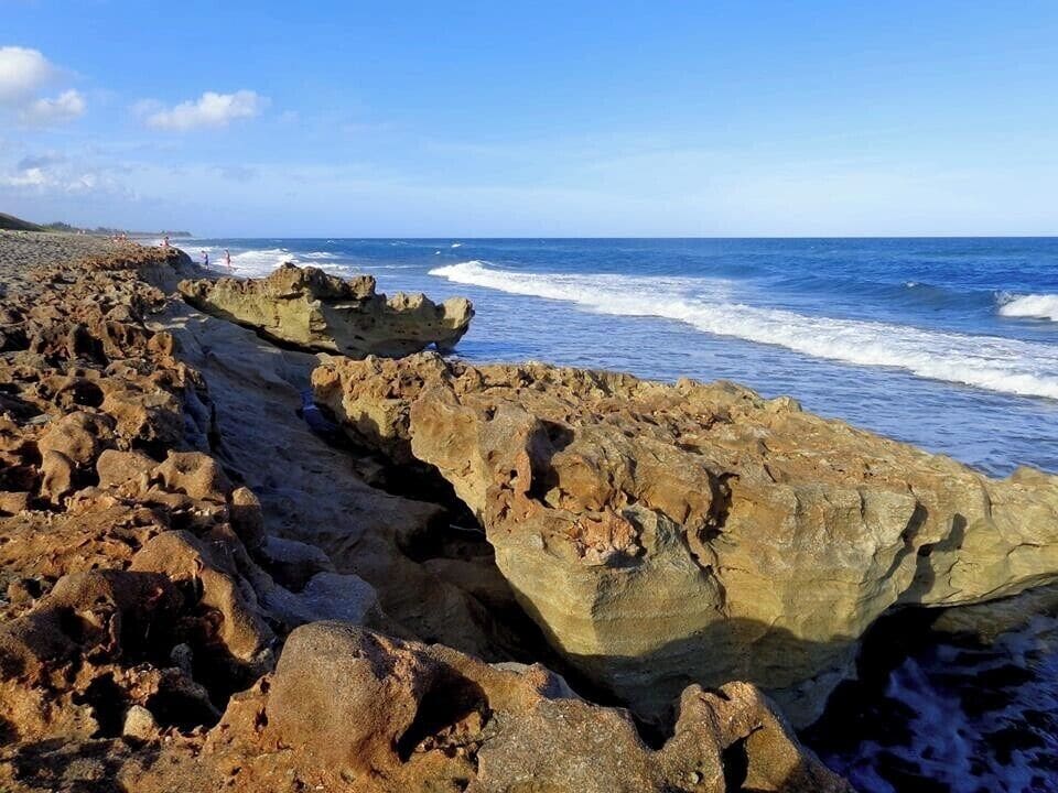 A rocky coastline with waves crashing against the shore.