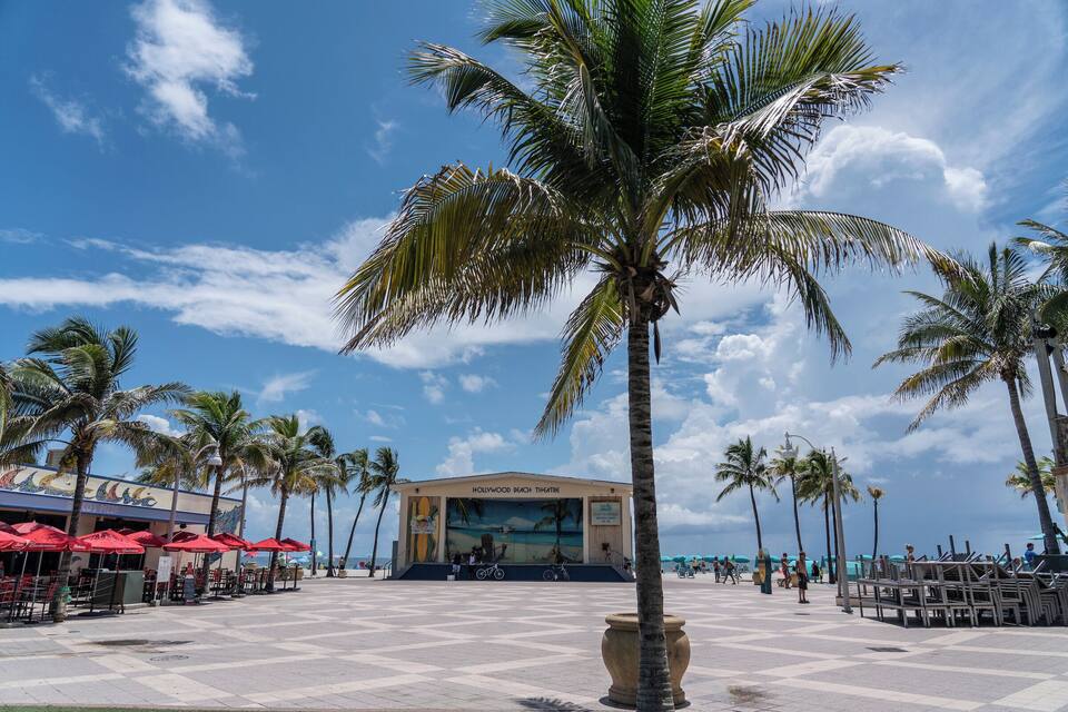 The Hollywood Beach Theatre with palm trees and beachside seating.