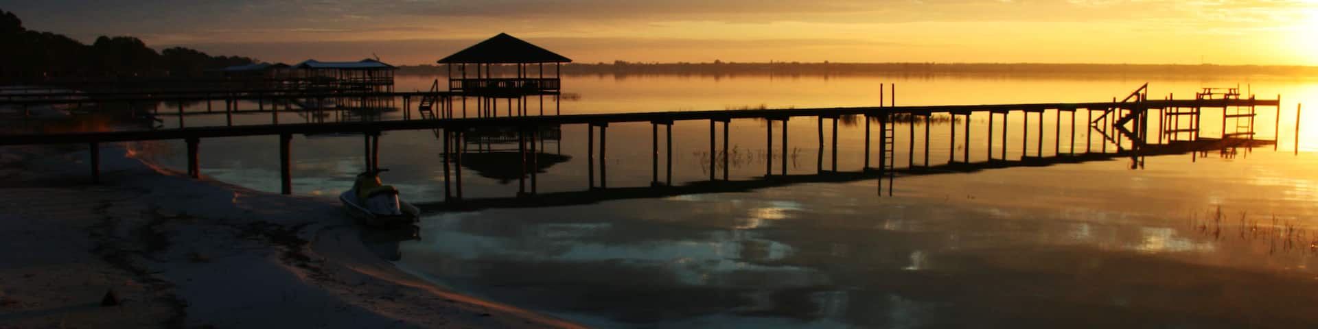 Boat pier at sunrise in Lake Placid Florida; Shutterstock ID 59026585