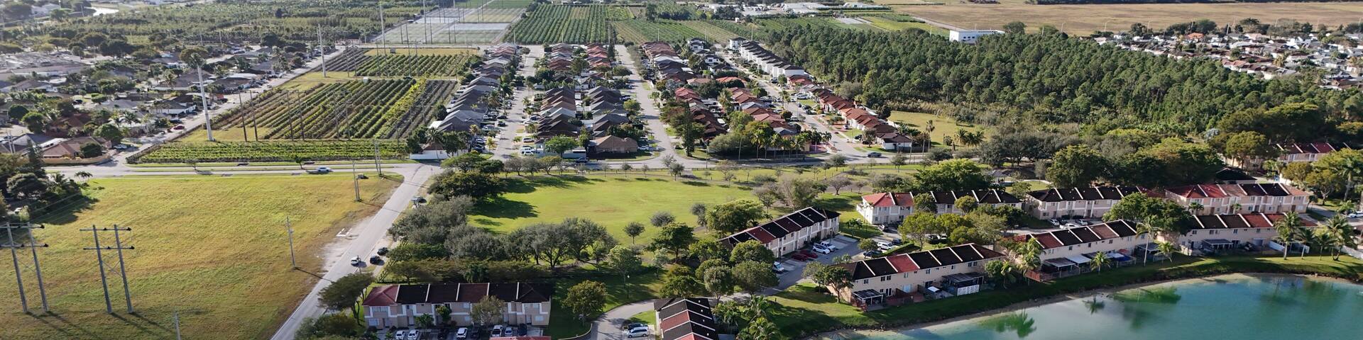 Aerial view of a suburban community and lake in South Miami-Dade