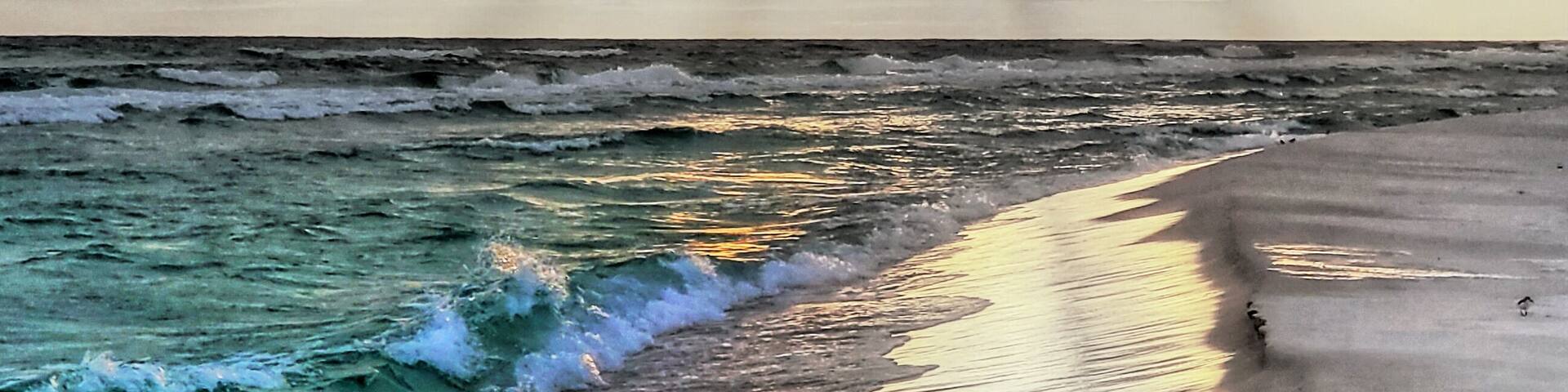 Its white sand beach for miles by hwy 30A. And right around sunrise and sunset you get some very nice Light